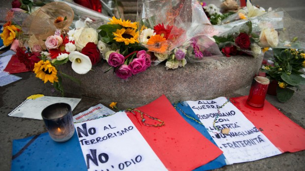 WEB &#8211; A French flag, flowers and peace symbol in Piazza Fontana