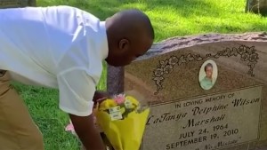CHILD VISITING MOTHER'S GRAVE
