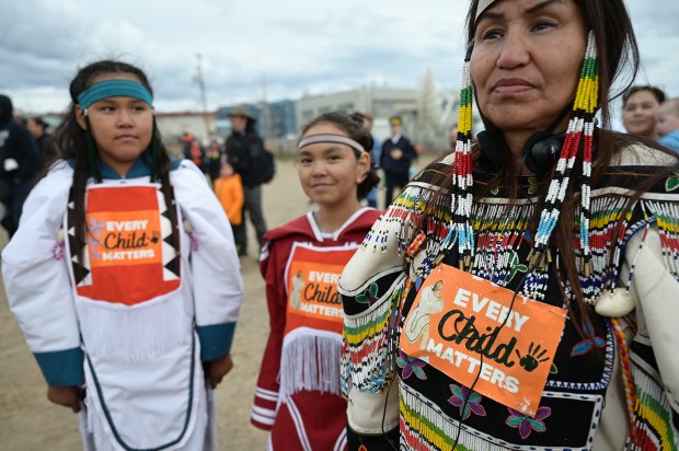 Indigenous-women-wearing-Every-Child-Matters-on-their-clothes-AFP
