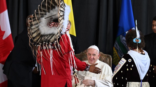 Pope-Francis-speaks-with-member-of-an-indigenous-tribe-during-his-welcoming-ceremony-at-Edmonton-International-AFP