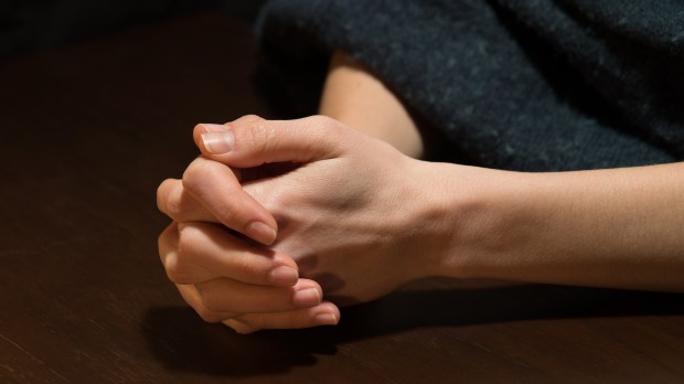 prayer-hands-woman-shutterstock_2188707231.jpg