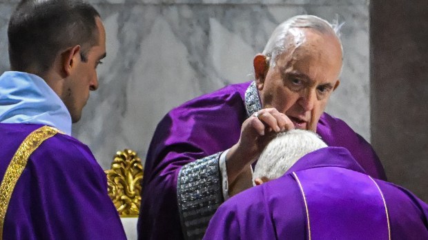 Pope Francis prays during the celebration of Ash Wednesday