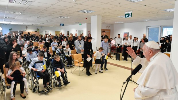 Pope Francis gives his blessing as he visits children of the Blessed Laszlo Batthyany-Strattmann Institute during his apostolic journey in Budapest Hungary