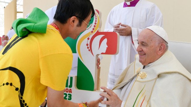 Pope Francis receives a JMJ (WYD) plaque from a volunteer during the closing mass of the World Youth Days
